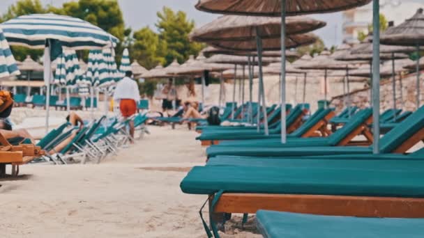 Reposeras vacías en la playa de arena contra el mar Turquesa, Albania, Ksamil — Vídeo de stock