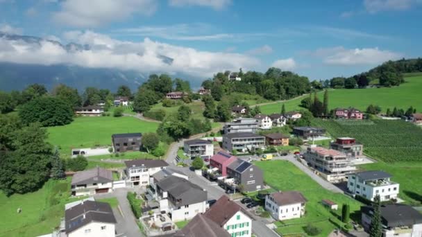 Aerial view of Liechtenstein with Houses on Green Fields in Alps Mountain Valley — Stock Video