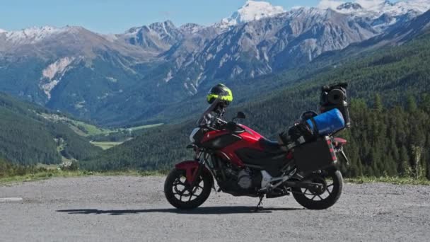 Motorbike with Motorcycle Cases Stands Against Mountain Landscape of Swiss Alps — Stock Video