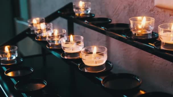 Burning Candles Inside Church Interior, Prayer Candles Lit in Row, Spirituality — Stock Video