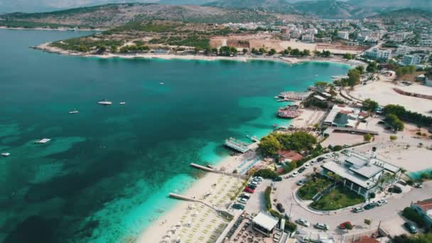 Aerial, Azure Beach with Empty Sun Loungers and Boats, Balkan Sea Coast, Albania — Stock Video
