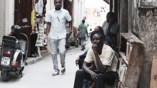 Triste africano se sienta en la calle pobre, hombre negro local, mirada triste, ciudad de piedra, Zanzíbar — Vídeos de Stock