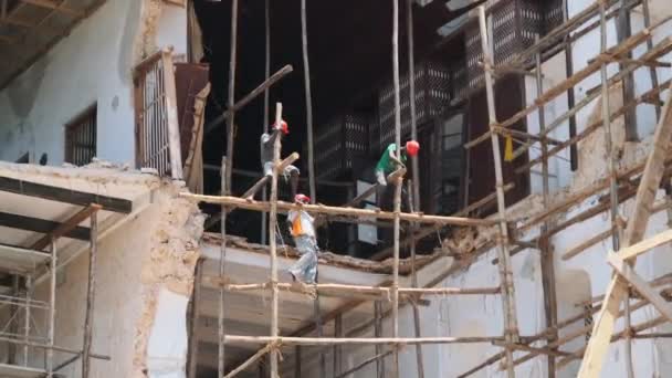 Constructores africanos reconstruyen un edificio en ruinas en Stone Town, Zanzíbar, África. — Vídeos de Stock