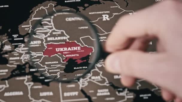 Ukraine on the World Map Under Magnifying Glass — Stock Video