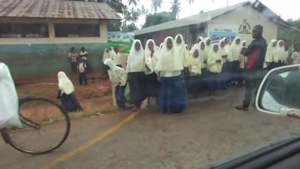 Crowd of African school children run out onto road in local village, driving car, Zanzibar — Stock Video