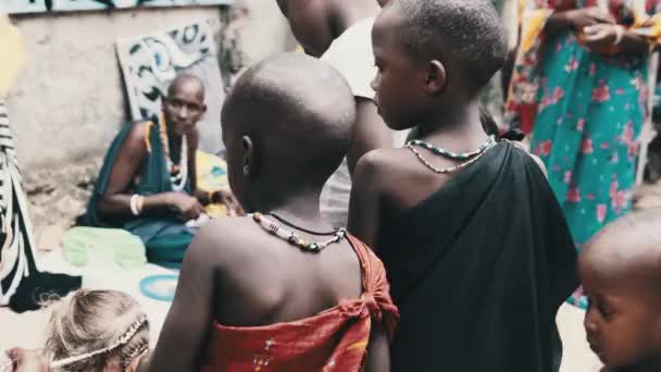 Local African Hungry Child Eats Paper on Street among People, Zanzibar, Africa — Stock Video