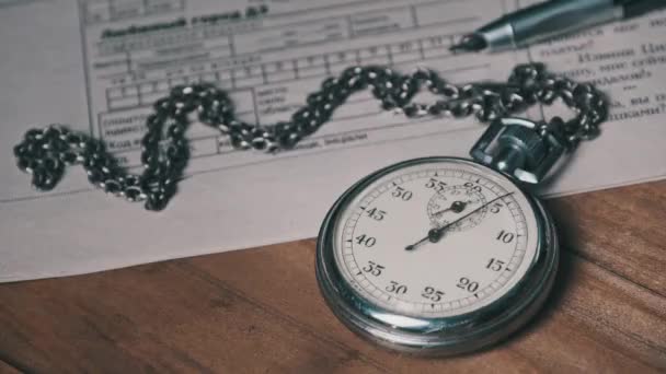 Antique Stopwatch Lies on Wooden Desk with Old Documents and Counts Seconds — Stock Video