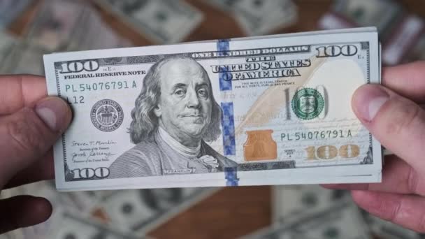 Dólares em mãos masculinas no fundo da mesa com dinheiro — Vídeo de Stock