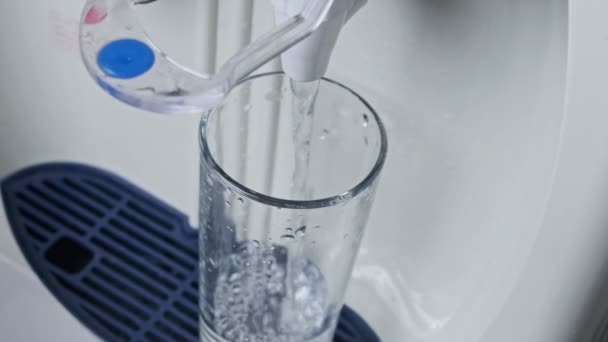 Водяной охладитель, чистая вода наливается в стекло из распределителя воды — стоковое видео