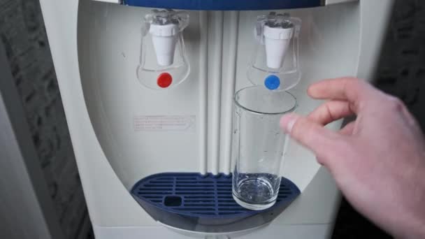 Tiszta víz ömlik az üvegbe a vízhűtőből. — Stock videók