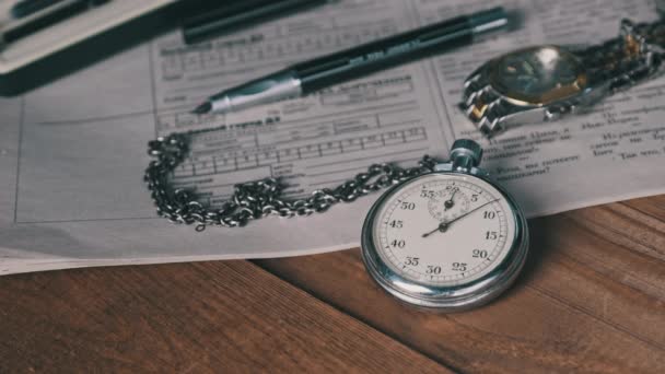 Antique Stopwatch Lies on Wooden Desk with Old Documents and Counts Seconds — Stock Video