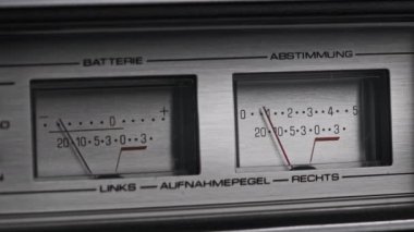 Gümüş renkli teyp kaydedicisinde iki analog VU ölçer, ok göstergeleri