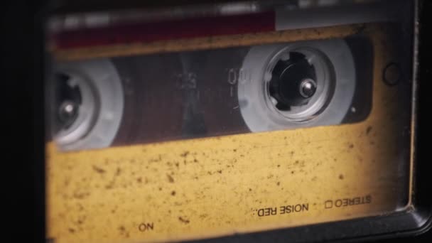 Casete de audio amarillo vintage tocando en la cubierta de una vieja grabadora de cinta — Vídeos de Stock