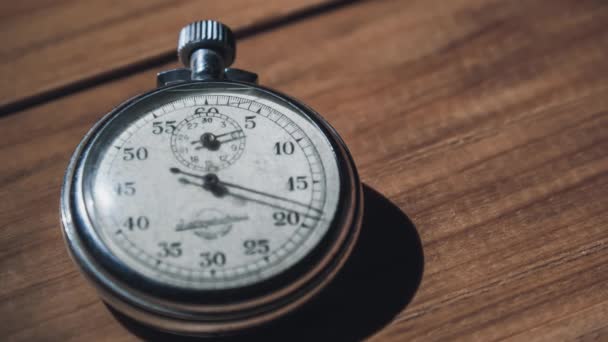 Timelapse of Antique Stopwatch Lies on Wooden Table and Counts the Seconds — Vídeos de Stock