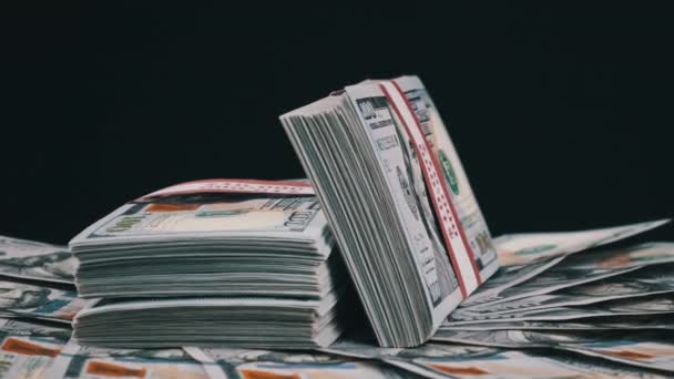 Bundles of Dollars Lying on a Pile of Money and Rotate on Black Background — Stock Video