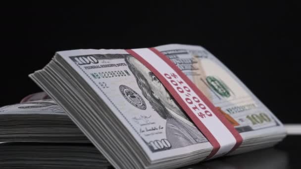Bundles of Dollars Rotate on Black Background — Stock Video