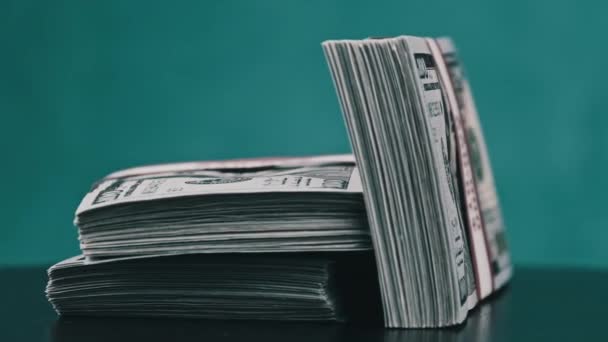 Bundles of Dollars Rotate on blue Background, Heap of Money — стоковое видео