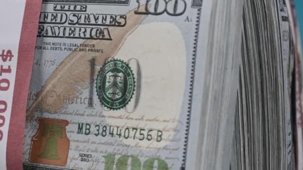 Пачки долларов вращаются на голубом фоне, куча денег — стоковое видео