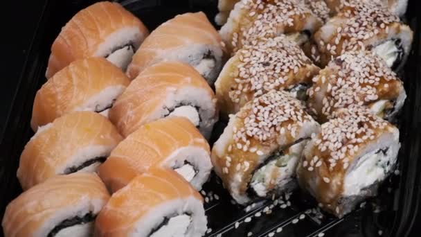 Sushi Rolls Rotating in Plastic Box — Vídeo de Stock