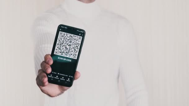 Man Shows QR Code on Smartphone and Shows Thumbs-Up Sign on White Background — Vídeos de Stock
