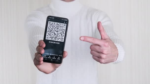 Male Hand Shows Code Smartphone White Background Inscription Mobile Phone — Stockvideo