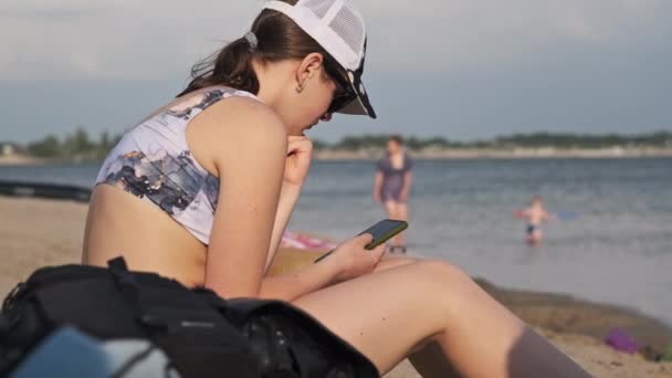 Young Woman Uses Smartphone Beach Beautiful Girl Swimsuit Sitting Beach — Stock Video