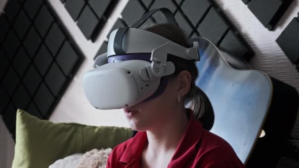 Young Woman Virtual Reality Helmet Sitting Sofa Communicating Virtual World — Stock Video