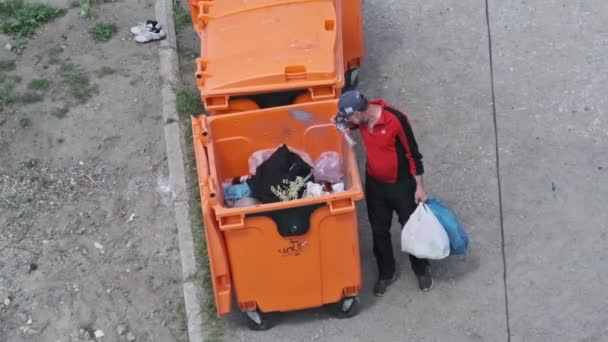 Homeless Man Digs Trash Can Street View Tramp Plastic Bottle — Stock Video