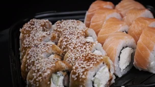 Sushi Rolls Plastic Box Rotating Close Takeaway Fresh Japanese Sushi — стоковое видео