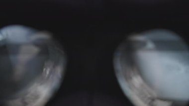 POV of putting on VR glasses virtual reality in the bedroom. Young male hands hold virtual reality helmet indoors. Virtual reality mask. Close-up. Point of view man taking of VR helmet at home.