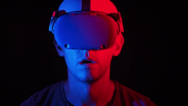 Man Virtual Reality Helmet Illuminated Red Blue Plays Game Young — Vídeos de Stock