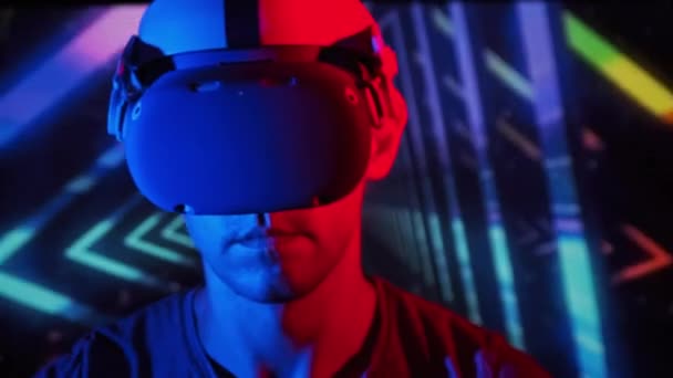 Young Man Plays Game Helmet Red Blue Light Active Man — Stockvideo