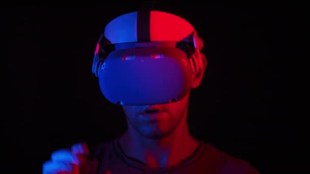 Young Man Plays Game Helmet Red Blue Light Active Man — Stockvideo