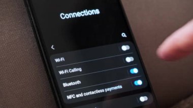 Akıllı bir telefondan Wi-Fi 'ı açıyorum. Kablosuz ağ düğmesi bağlantı menüsündeki cep telefonunu açar. Erkek parmak dokunuşu ekranda modern akıllı telefonda ekranda wi fi bölgesi ekranda.