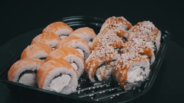 Sushi Rullar Plastlåda Roterar Närbild Färsk Japansk Sushi Med Philadelphiaost — Stockvideo