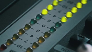 Karıştırma konsolundaki ses seviyesi sinyalinin LED göstergesi. VU çıkış göstergesinde yeşil ve sarı şeritli yakın çekim. Ses düzeyi ampulleri değişiyor. Ses çubuğundaki Stereo metre