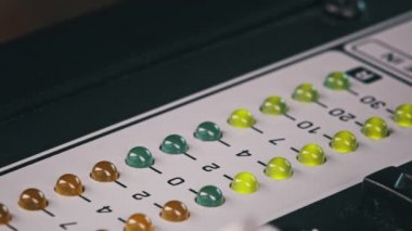 LED indicator of sound level signal on the mixing console. LED strip in green and yellow on output level indicator. Volume level changes of indicator lights. VU meters on the analog sound desk. Macro