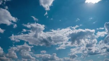 Clouds moving in the blue sky, timelapse. Puffy fluffy white clouds, time-lapse. Copy space. Cumulus light clouds change their shape in cloud space. Awesome sky. Change of weather. Nature background