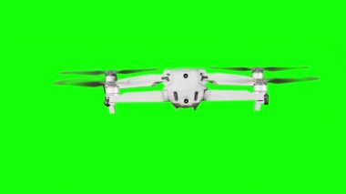 Real quadcopter with camera flights on a green screen. A drone hovering in the air with an alpha channel. Isolated portable copter on alpha matte. Aircraft blades rotate in hanging. Alpha channel 4K