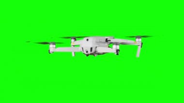 Drone hovering in the air on a green screen. Real quadcopter with camera flights on transparent background. Isolated portable copter on alpha matte. Aircraft blades rotate in hanging. Alpha channel 4K