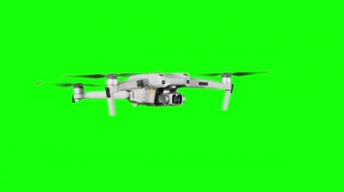 Drone hovering in the air on a green screen. Real quadcopter with camera flights on transparent background. Isolated portable copter on alpha matte. Aircraft blades rotate in hanging. Alpha channel 4K