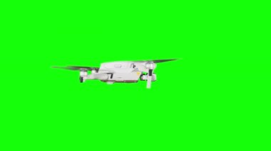 Real quadcopter with camera flights on a green screen. A drone hovering in the air with an alpha channel. Isolated portable copter on alpha matte. Aircraft blades rotate in hanging. Alpha channel 4K