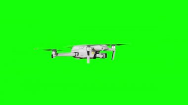 Real quadcopter with camera flights on a green screen. A drone hovering in the air with an alpha channel. Isolated portable copter on alpha matte. Aircraft blades rotate in hanging. Alpha channel 4K