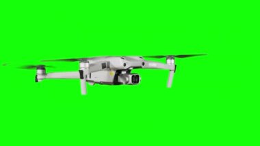 Real quadcopter with camera flights on a green screen. A drone hovering in the air with an alpha channel. Isolated portable copter on alpha matte. Aircraft blades rotate in hanging. Alpha channel 4K