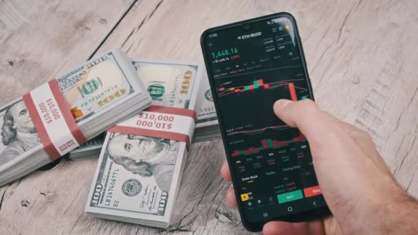 Trader Menganalisis Harga Cryptocurrency Ethereum Pada Layar Smartphone Atas Meja — Stok Video