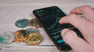 Şifreli akıllı telefon ticareti. İşadamı şifreli paralarla birlikte dijital borsada kripto fiyat tablosunu kontrol ediyor. BTC fiyatı. Kripto para ticareti. Çevrimiçi piyasa, değişim grafiği, Bitcoin