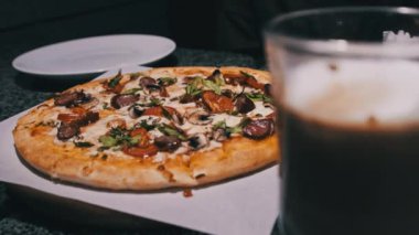 Restorandaki masada taze pizza var. Pizzacının iştah açıcı pizzasından bir dilim. 4K