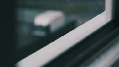 Sonbahar Melankolisi, yağmur damlaları pencerenin kenarına ağır çekimde vuruyor. Yağmurlu bir günde yağmur damlaları pencere pervazına düşer, ağır çekimde. Fırtına sırasında pencere pervazı, yakın çekim. Güz yağmuru ve gri bir ruh hali