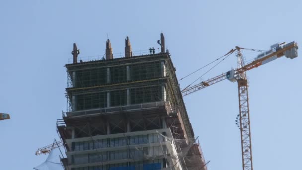 Timelapse Construction Modern Skyscrapers Using Tower Cranes Background Blue Sky — Vídeo de stock