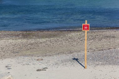 Warning mine sign installed on the beaches of the Black Sea coast of Odessa. War in Ukraine 2022